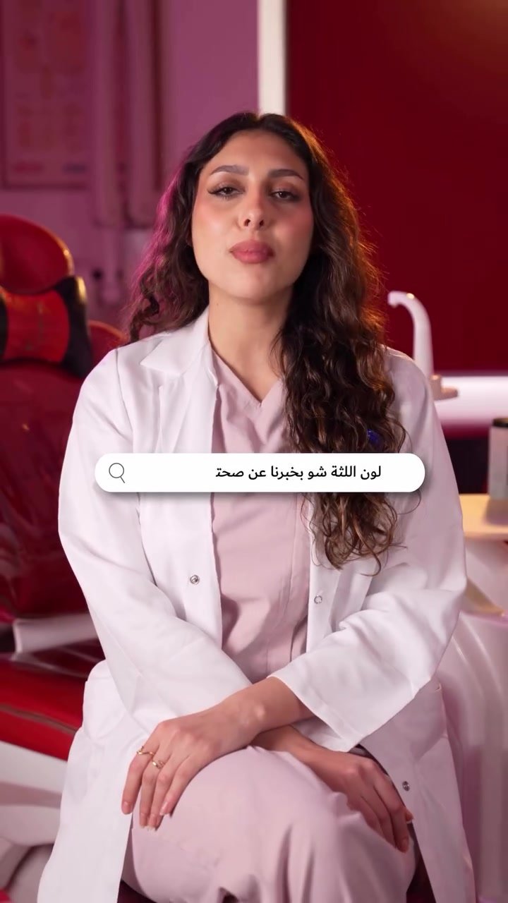 Dentist in a white coat speaking to camera
