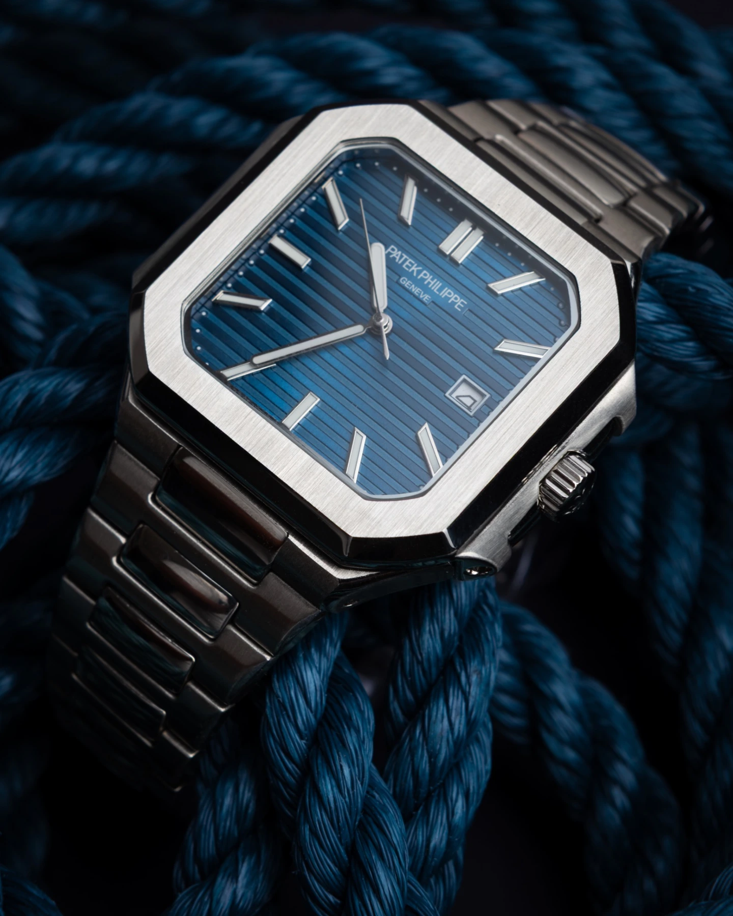 Blue dial watch on navy rope