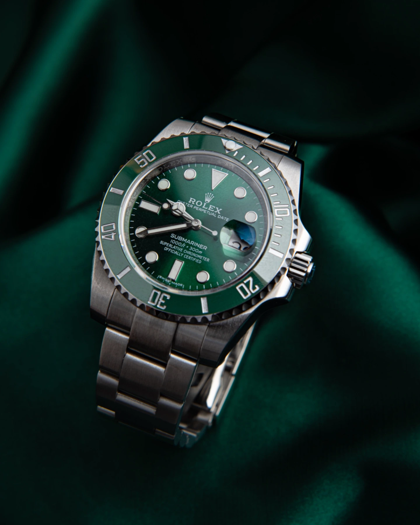 Green dial watch on green fabric